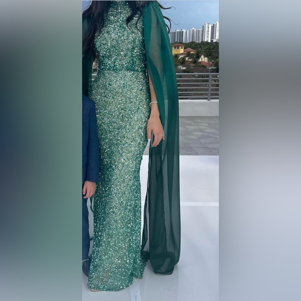 Fjolla Nila green beaded gown with cape sleeves.